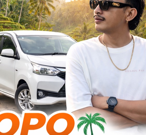 Opo, a local Balinese private driver, standing beside his car in Bali